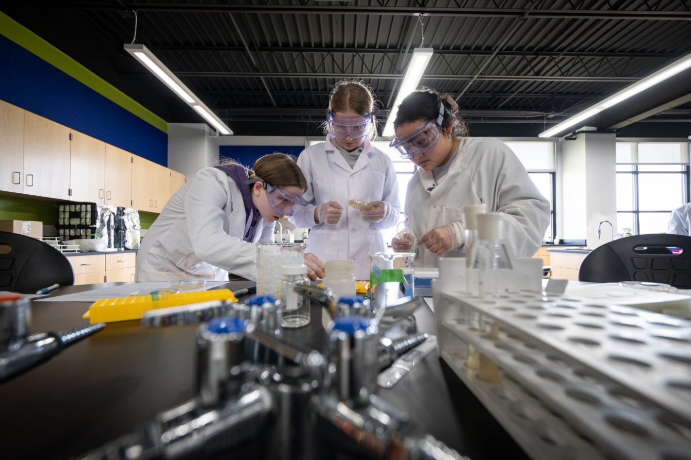 Three students doing a science experiment