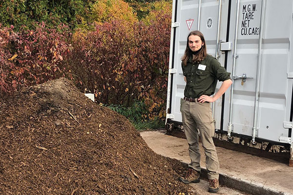 Bryce Oysti, EMBI Intern with UWGB industrial composter