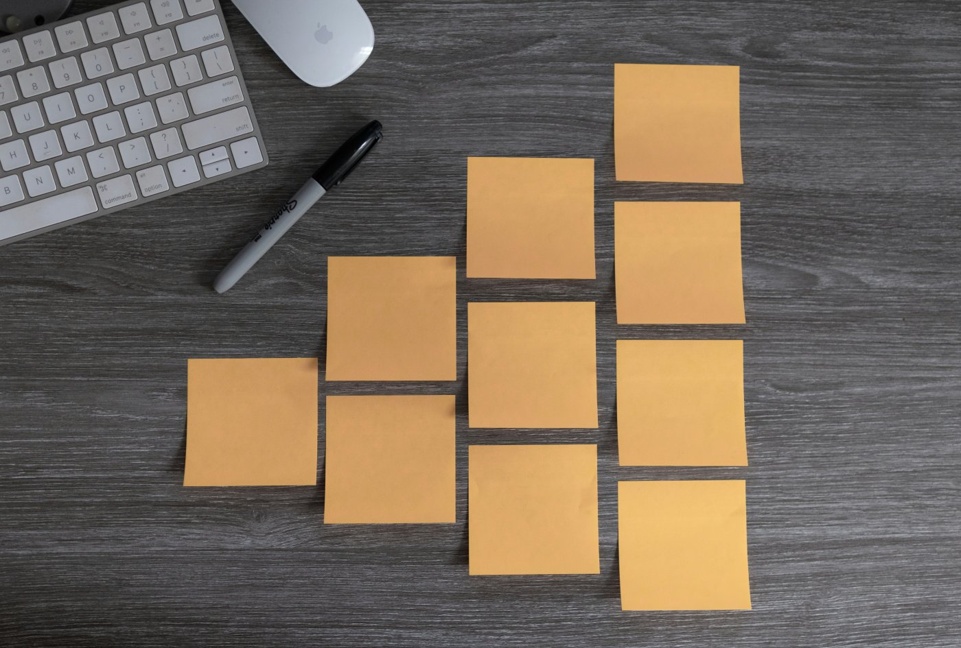 a desk with sticky notes and a marker