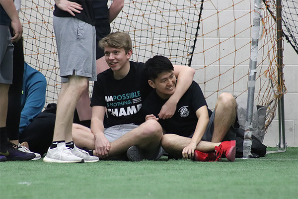 Students on the sideline in the uwgb indoor turf gym