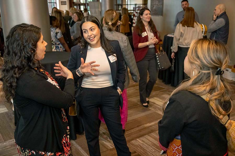 three women talking in the Weidner foyer before Celebrate 2025