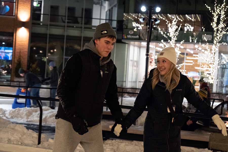 Two students ice skating at Titletown ice rink