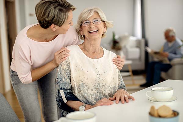 administrator talking to resident sitting at table