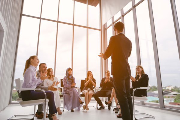 Business man giving speach to coworkers