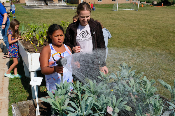 UW-Green Bay student gardening with the Boy's and Girl's club