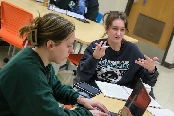 Two students engaging in class discussion