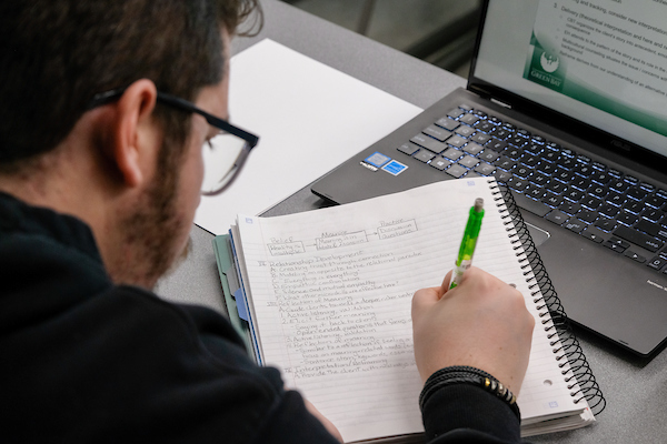 Student taking notes in class