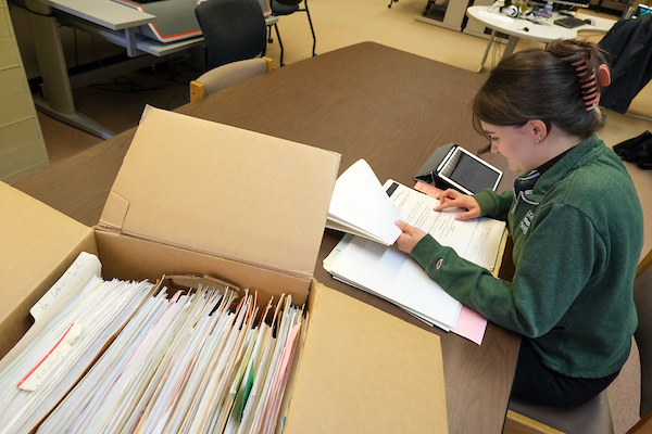 Student sorting through archives